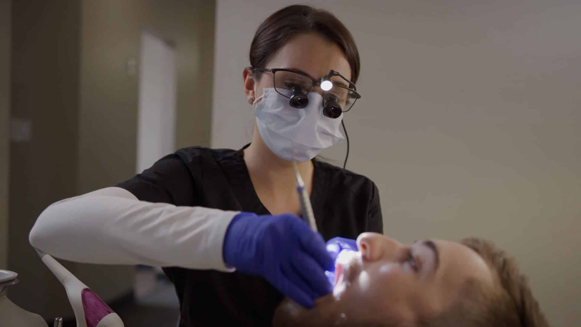 dentist checking the teeth of a patient