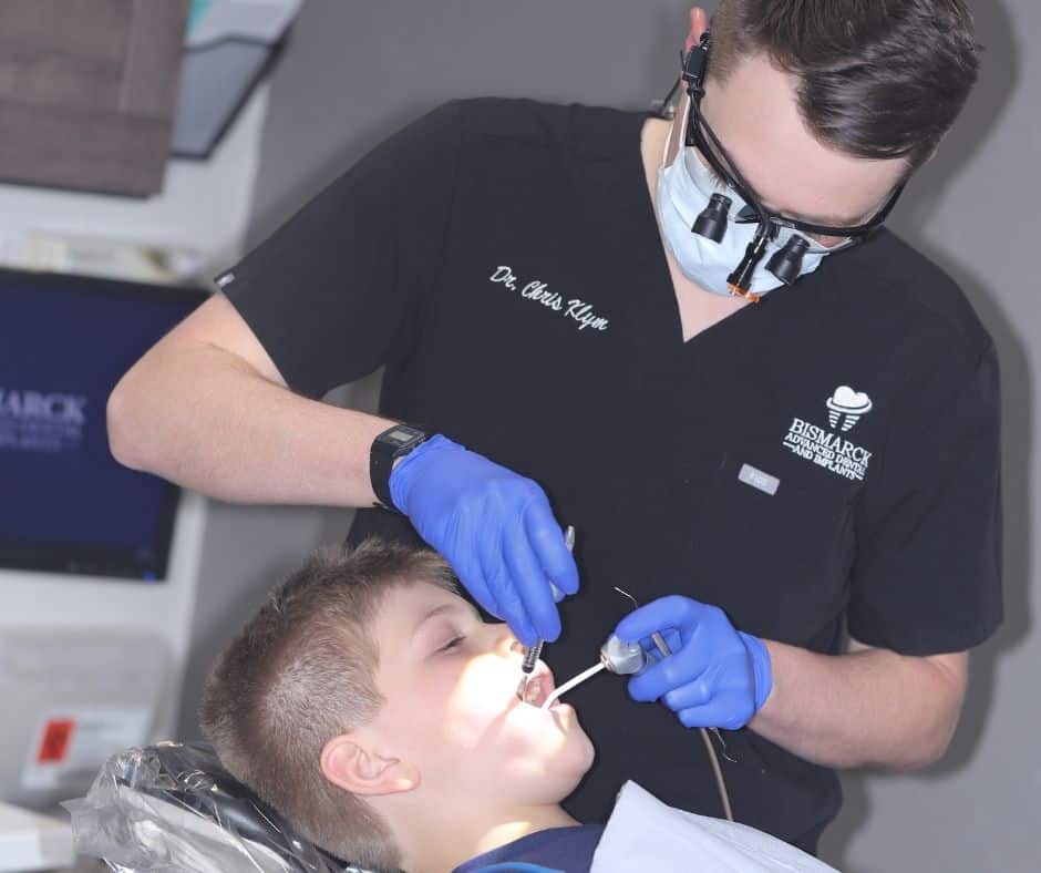 Dr. Christopher Klym doing a procedure on a boy
