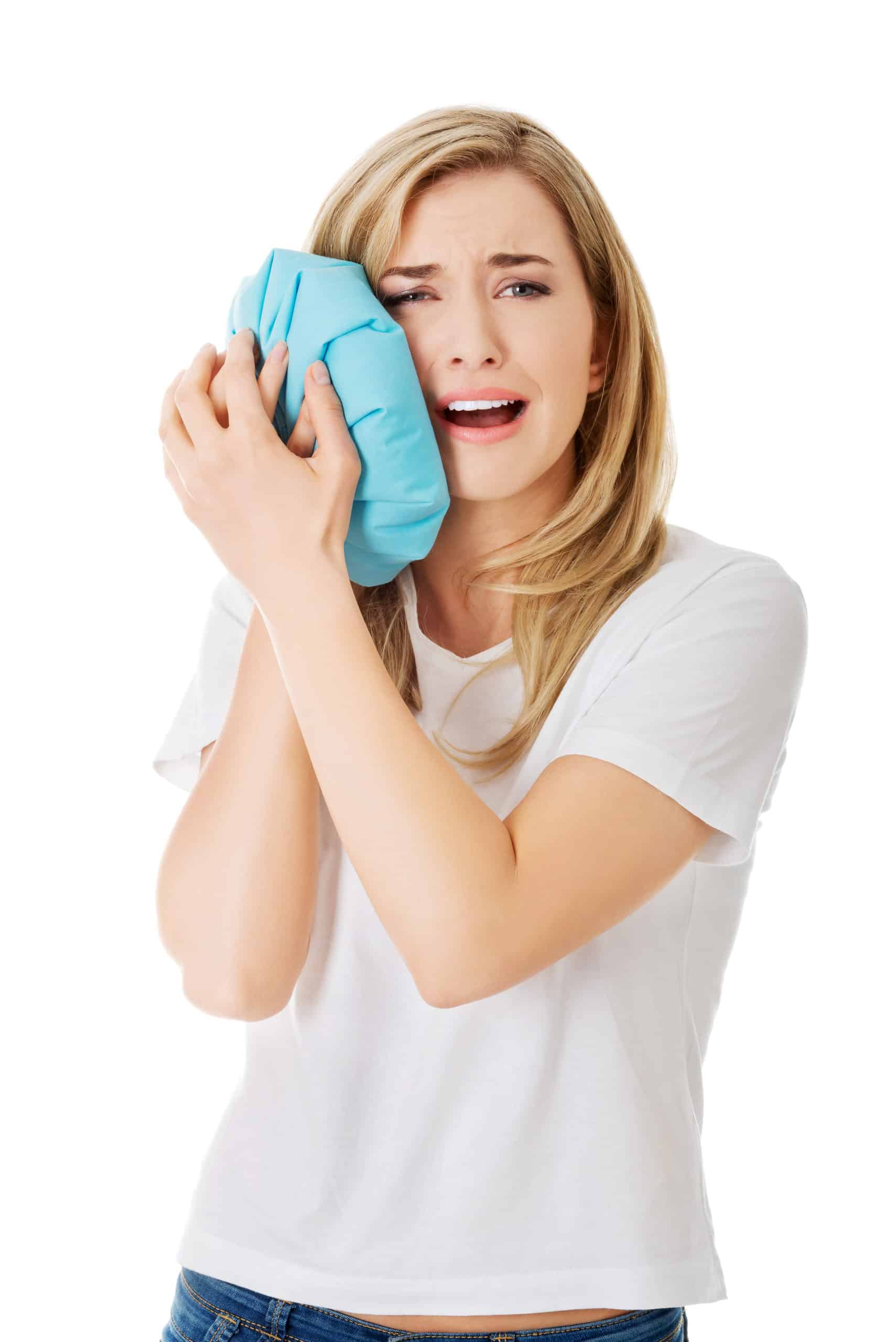 Woman heaving tooth ache, holding ice bag