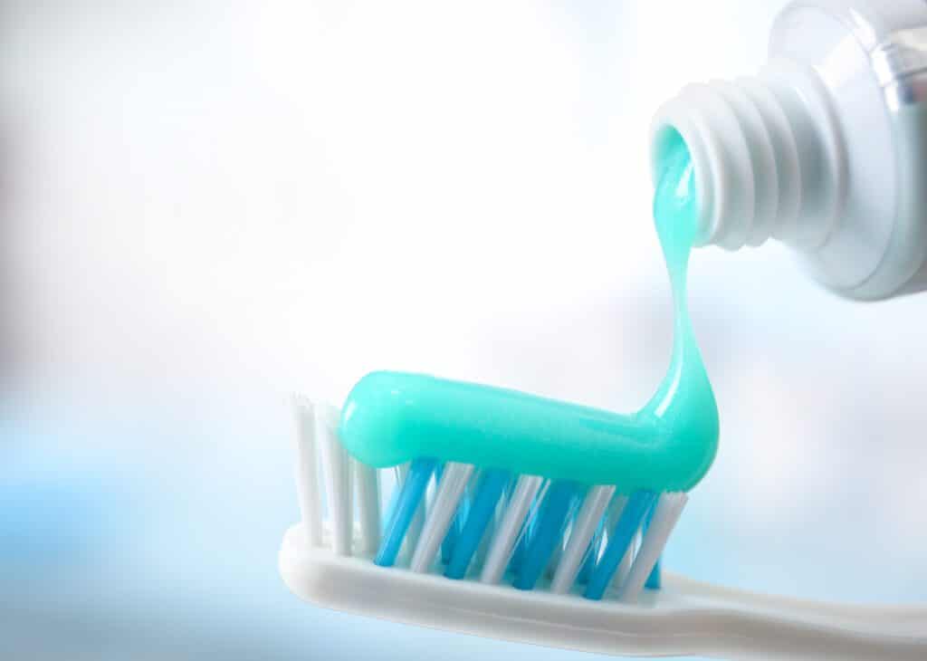 Toothbrush and toothpaste on blurred background. Fluoride Help