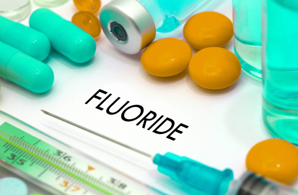 Fluoride. Treatment and prevention of disease. Syringe and vaccine. Medical concept. Selective focus. Fluoride Help